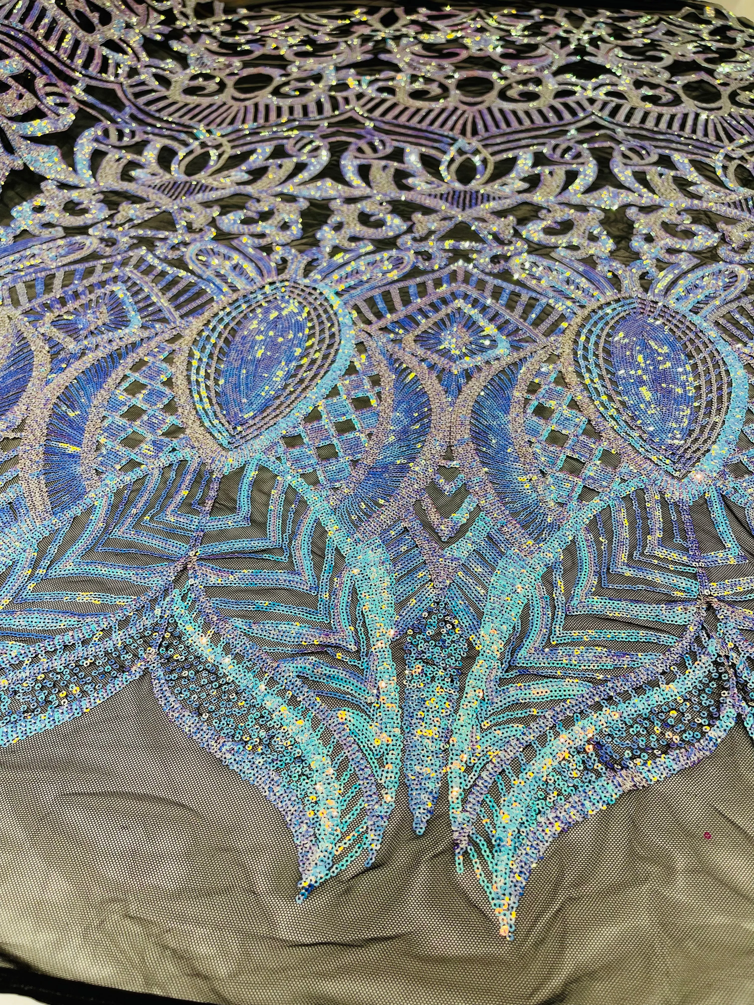 Aqua iridescent royalty design on a black 4 way stretch mesh-prom-sold by the yard.